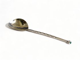 An Arts & crafts sterling silver twist-stem handle spoon. With inset gem.