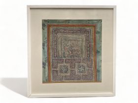 A large framed Chinese silk border and woodblock print interior (possibly Indian). 51.5cm x 57.5cm