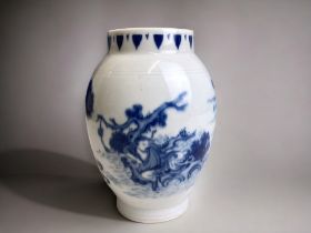 A Chinese blue & white porcelain vase. Painted seated figure amongst a seascape. Incised design to