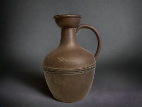 A CHRISTOPHER DRESSER DESIGN FOR HENRY LOVERIDGE & CO COPPER WATER JUG. CIRCA 1890. HEIGHT - 19.