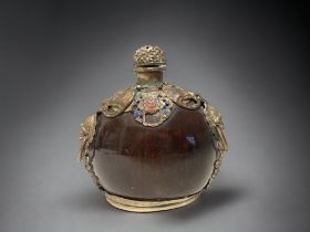 A Chinese polished Nut, metal mounted large snuff bottle. Marks to base. Height - 11.5 cm