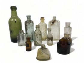 A mixed collection of antique glass bottles.