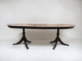 A MAHOGANY EXTENDING TRIPOD DINING TABLE. CENTRAL LEAF. METAL LION PAW CASTERS.