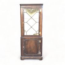 A 19TH CENTURY MAHOGANY GLAZED CORNER CABINET.