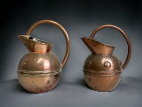 TWO 19TH CENTURY CHRISTOPHER DRESSER ATTRIBUTED COPPER WATER JUGS. BY HENRY LOVERIDGE. CIRCA 1885.