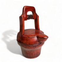 A Chinese wood & red lacquer covered water jug. With pierced fretwork handle. Height - 38.5cm