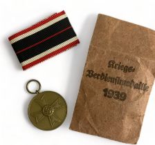 1939 German 'For War Merit' medal, 'Für Kriegsverdienst', complete with unused ribbon and paper