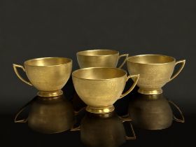 FOUR SCARCE MINTON CHINA GILDED TEACUPS. RICH GILT GROUND WITH TOOLED STYLISED FOLIATE DESIGN.