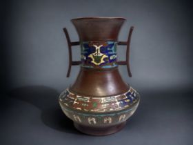 A JAPANESE BRONZE ENAMEL CHAMPLEVE VASE. MEIJI PERIOD. TWIN HANDLED ARCHAISTIC STYLE DESIGN.