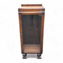 An Art Deco Oak Reynolds & co, glass fronted bookshelf / display case. Raised on ball feet. 112cm