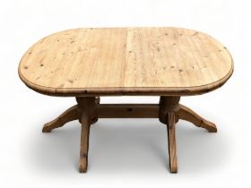 A TWIN PEDESTAL PINE DINING TABLE. 142cm x 90cm wide x 70cm tall insert is 43cm