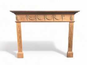 A CARVED PINE FIRE SURROUND. EXTERNAL 156CM WIDE X 117CMTALL X 28CM DEEP INTERNAL 116CM X 91CM X