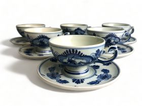 A COLLECTION OF SIX VINTAGE HAND PAINTED DELFT BLUE & WHITE TEACUPS & SAUCERS.