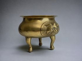 A Chinese polished bronze Tripod incense burner, with lion mask handles, complete with lotus leaf