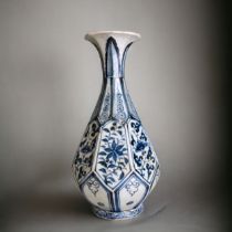 A Yuan dynasty blue & white vase. Pear shape, faceted octagonal form. Rising from a conforming