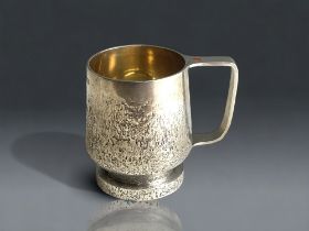 A rare Guy Wilson sterling silver mug. Bark effect design with inset cabochon to handle. Makers