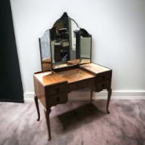 A VINTAGE MID-CENTURY DRESSING TABLE. WITH ADJUSTABLE MIRRORS, FOUR DRAWERS AND CABRIOLE LEGS.