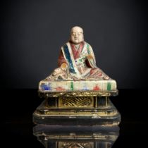 A CHINESE CARVED WOOD POLYCHROME FIGURE OF BUDDHISTIC MONK. QING DYNASTY. ON BLACK & GILT BASE. WITH