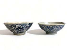 A pair of Chinese 'Kitchen Qing' porcelain bowls. 18th/19th century. Painted blue foliate design.