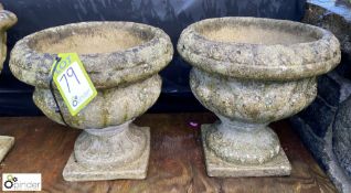 A pair of reconstituted stone Urns with gadrooning