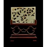 A RETICULATED CHINESE WHITE JADE PLAQUE, MOUNTED ON ROSE WOOD, 18TH CENTURY