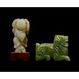 A CHINESE RUSSET JADE FIGURE OF A BOY & A SPINACH JADE FIGURE OF A MYTHICAL BEAST, 18TH/19TH CENTURY