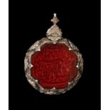 A CARVED ISLAMIC CARNELIAN CALLIGRAPHIC SEAL PENDANT, SET ON SILVER 19TH CENTURY