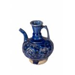 A COBALT BLUE MOULDED GLAZED KASHAN EWER, 12TH CENTURY PERSIA