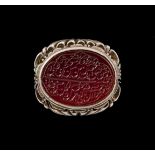 A CARVED ISLAMIC CARNELIAN CALLIGRAPHIC SEAL RING, SET ON SILVER 19TH CENTURY