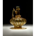 A HIGHLY RARE FATIMID FLUTED GLASS EWER, CIRCA 10TH CENTURY, EGYPT