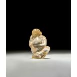 A BACTRIAN ROCK CRYSTAL FIGURINE OF A SEATED MONKEY, CIRCA 2ND MILLENIUM B.C.