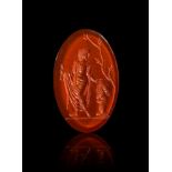 A GREEK CARNELIAN INTAGLIO OF A MAN AND A BUST HELLENISTIC PERIOD, CIRCA 2ND-1ST CENTURY B.C.