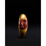 A ROMAN GOLD BABY RING IWTH A JASPER INTAGLIO OF A SOLDIER, CIRCA 1ST-2ND CENTURY A.D.