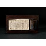 A NEAR EASTERN AGATE CYLINDER SEAL DEPICTING A GODDESS WITH CUNEIFORM SCRIPT