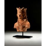 A GANDHARA TERRACOTTA BUST OF A CROWNED KING, CIRCA 5TH CENTURY CE OR LATER