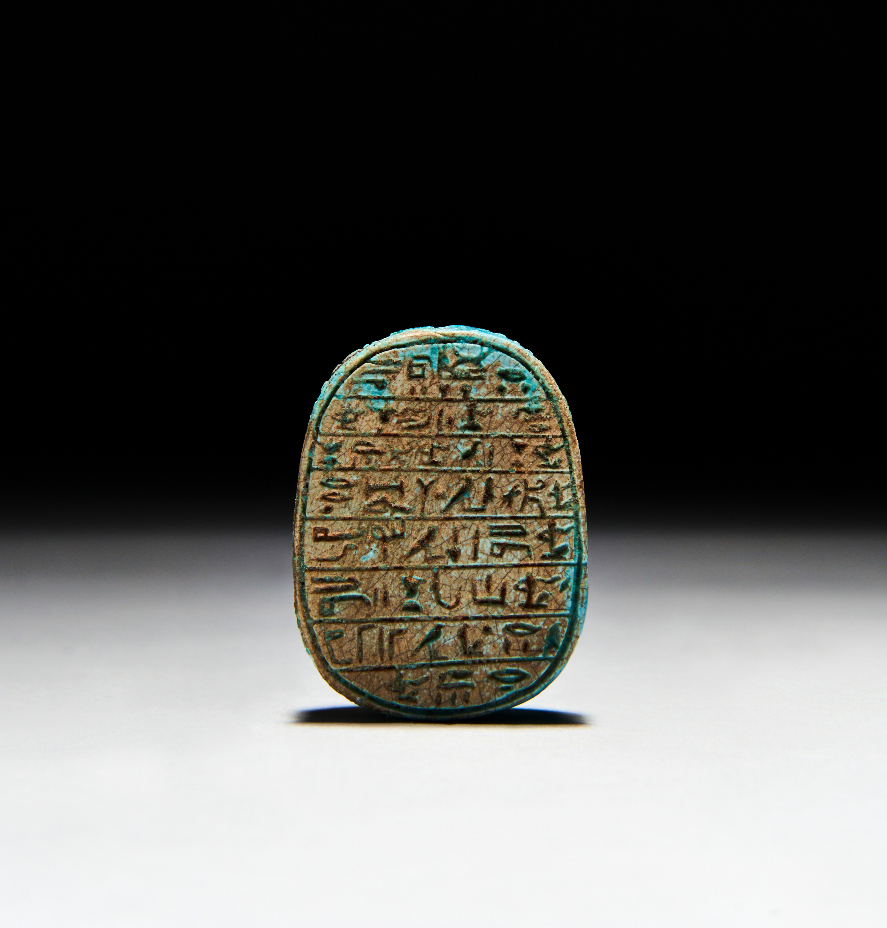 AN INSCRIBED EGYPTIAN TURQUOISE FAIENCE SCARAB PTOLEMAIC PERIOD (332-30 B.C.) - Image 2 of 2
