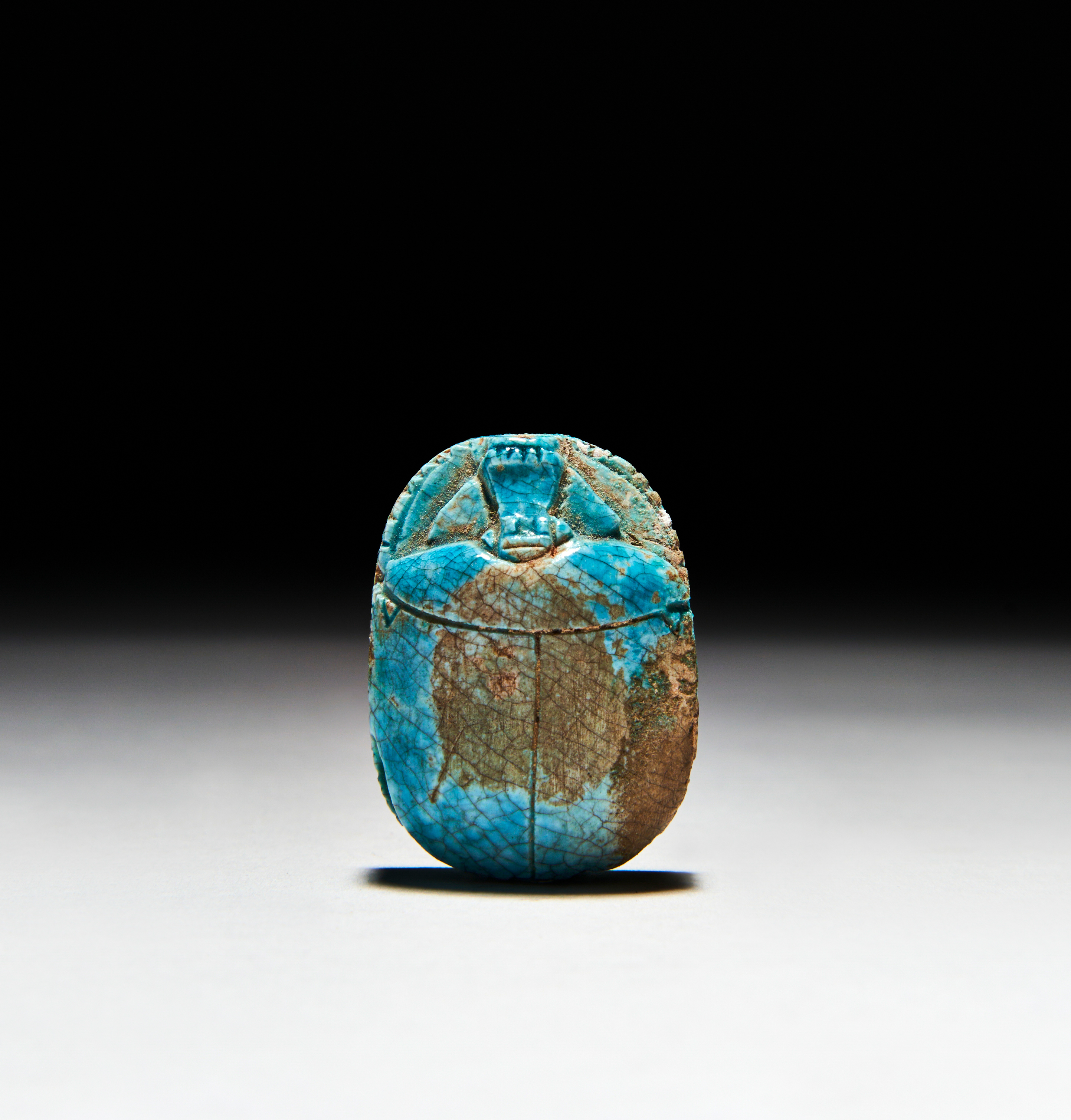 AN INSCRIBED EGYPTIAN TURQUOISE FAIENCE SCARAB PTOLEMAIC PERIOD (332-30 B.C.)