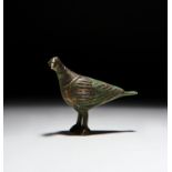 A SILVER INLAID SELJUK BRONZE BIRD PENDANT, PERSIA, 12TH CENTURY