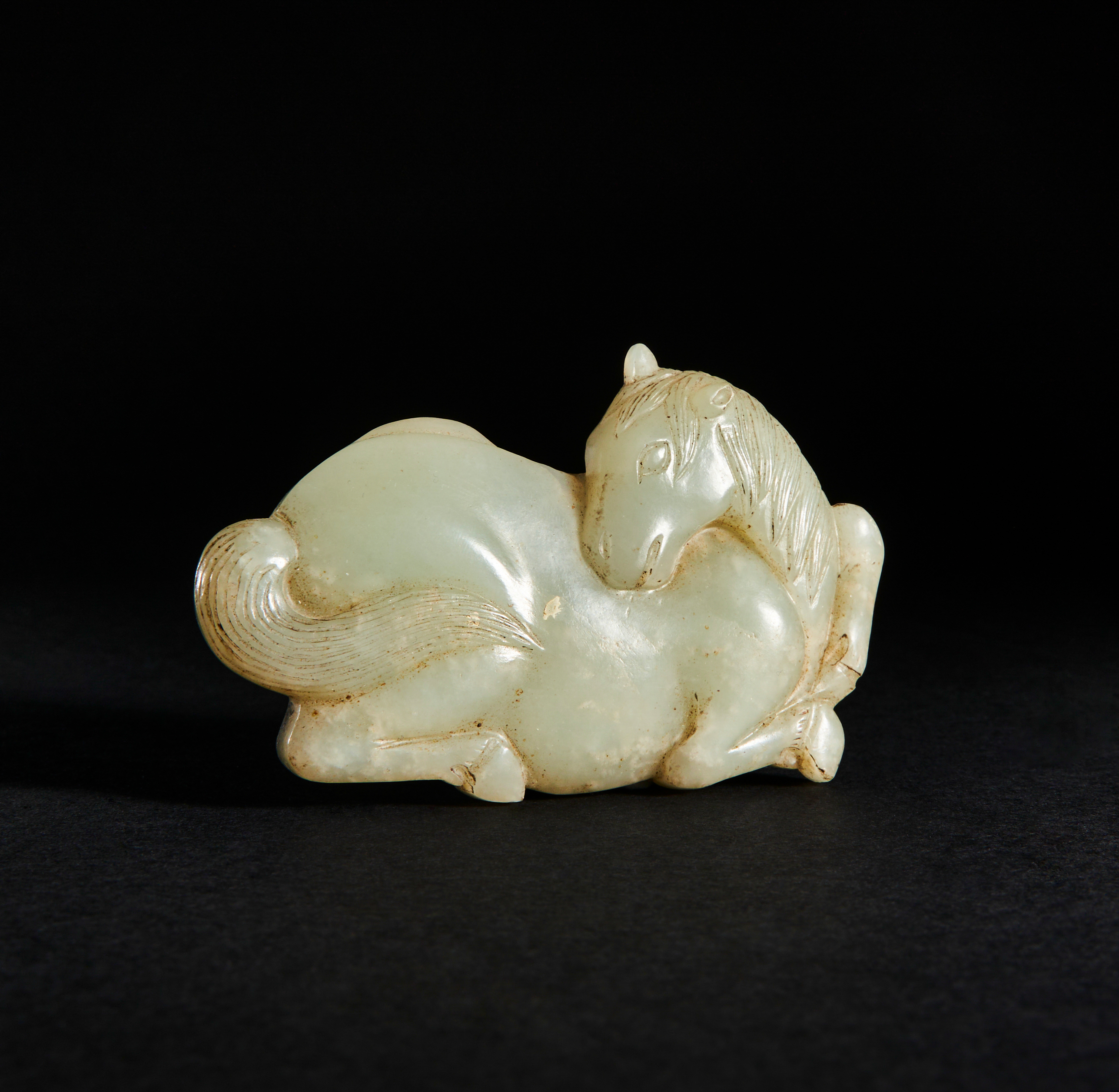 A CHINESE JADE BELT HOOK OF A RECUMBENT HORSE, QING DYNASTY (1644-1911)