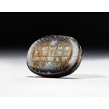 A SARDONYX LATIN INSCRIBED INTAGLIO, CIRCA 7TH CENTURY A.D.