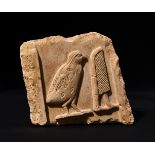 AN EGYPTIAN INSCRIBED LIMESTONE RELIEF FRAGMENT OF A PLAQUE DEPCITING A QUAIL & HYROGLYPHICS