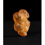 AN ACHAEMENID ROCK CRYSTAL SEATED BABOON AMULET FIRST HALF OF 5TH CENTURY B.C