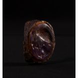 A ROMAN AMETHYST INTAGLIO OF A GRIFFIN TAUNTING A SNAKE ON AN IRON RING, CIRCA 1ST CENTURY A.D.