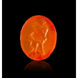 A GREEK CARNELIAN INTAGLIO OF A MAN HOLDING OLIVE LEAVES, CIRCA 3RD CENTURY A.D.