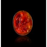 A GREEK BLOOD AGATE INTAGLIO OF A NAKED WARRIOR HOLDING SPEARS, CIRCA 3RD CENTURY A.D.