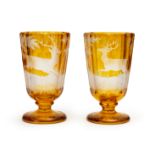 TWO AMBER BOHEMIAN GLASS BEAKERS, DEPICTING HUNTING SCENES, 19TH CENTURY