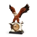 A CERAMIC CLOCK DECORATED WITH AN EAGLE