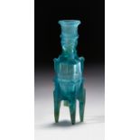 A RARE FATIMID BLUE "MOLAR FLASK" CUT GLASS BOTTLE, 10TH CENTURY, EGYPT