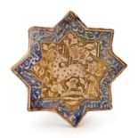 A KASHAN MOULDED LUSTRE STAR TILE IRAN, EARLY 14TH CENTURY