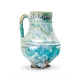 A BLUE GLAZED TURQUOISE KASHAN JUG, 12TH CENTURY, PERSIA